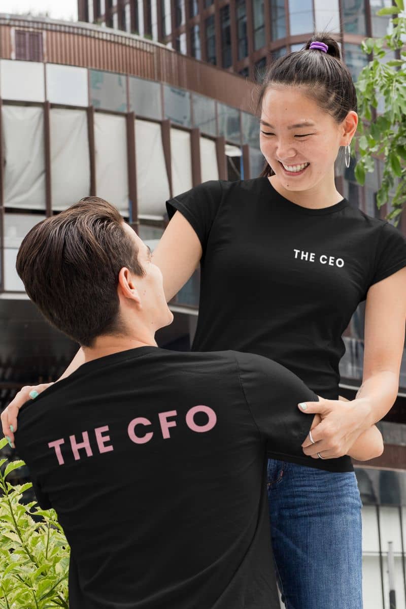funny couple t-shirts with two people wearing black t-shirts with 'THE CEO' and 'THE CFO' text, standing outdoors.