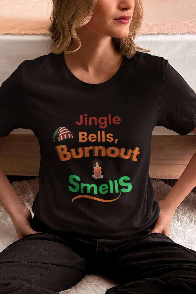 funny holiday graphic tee with a person wearing a black t-shirt with humorous text 'Jingle Bells, Burnout Smells'