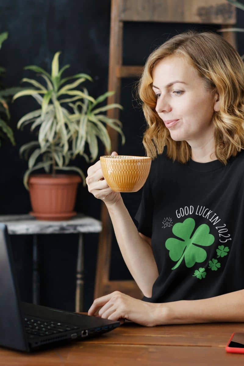 Good Luck in 2025 T-Shirt with a girl working on a laptop and a cup of hot tea