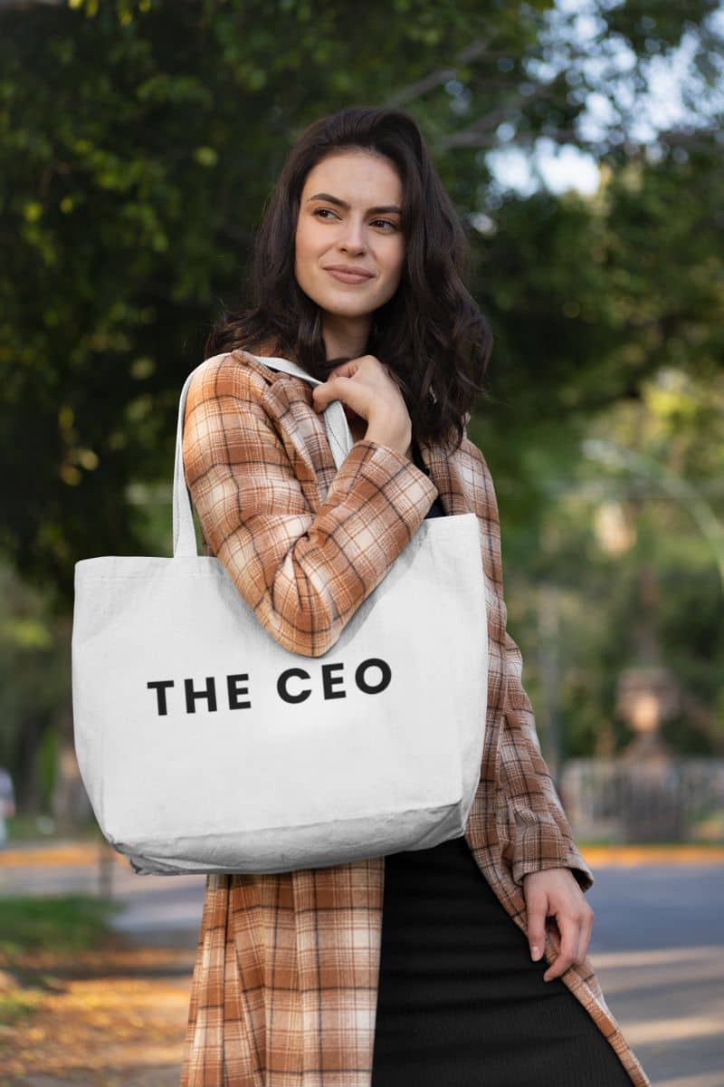 lightweight shopping tote with a woman holding a tote bag with 'THE CEO' text outdoors