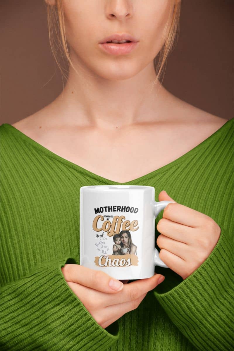 motherhood mug with humor with a person holding a mug with 'Motherhood Powered by Coffee and Chaos' text