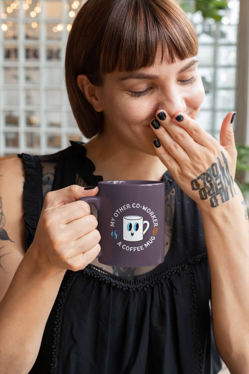 sarcastic coffee mugs with a woman holding a purple mug with text and a cartoon character, indoors.