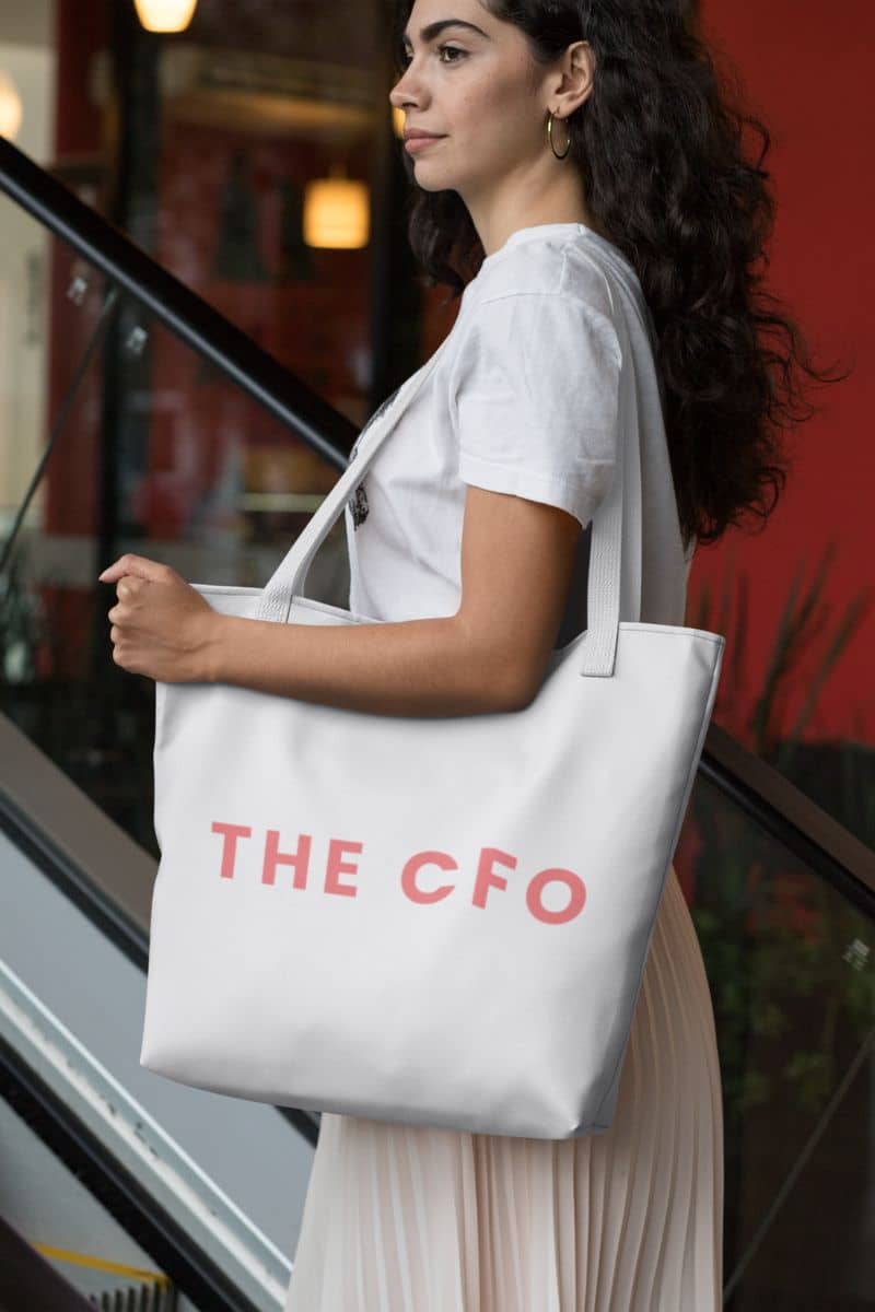 trendy tote for women with a woman holding a tote bag with 'THE CFO' text in an urban setting