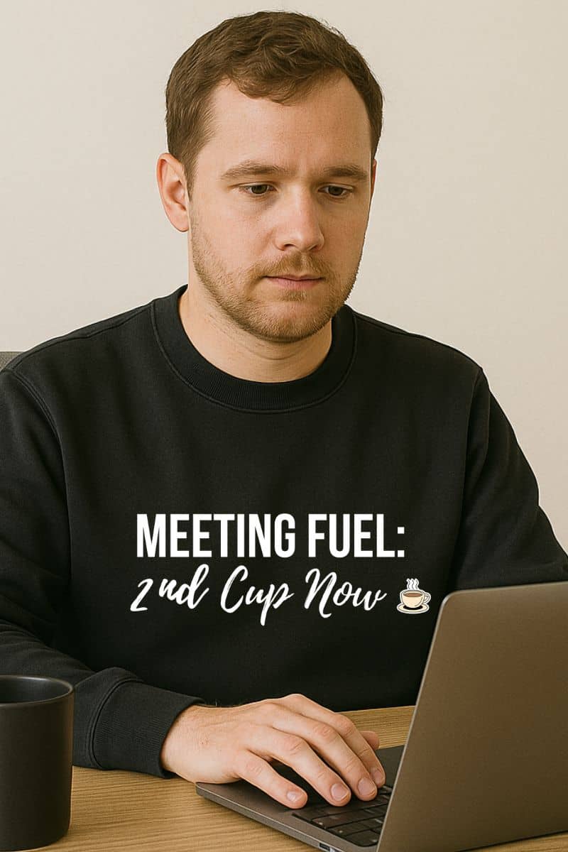 weekend coffee vibes sweatshirt with a man wearing a black sweatshirt with text sitting at a laptop.
