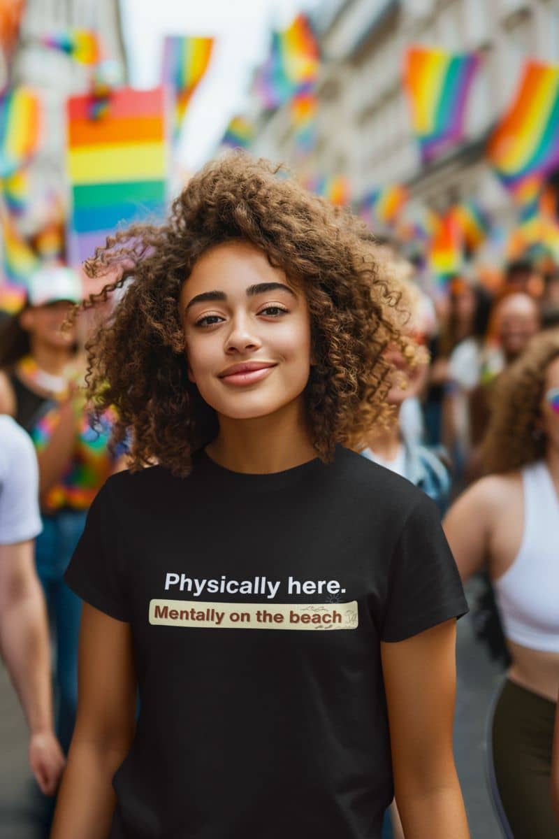 witty travel shirt with a person wearing a black t-shirt with humorous text at a Pride parade.