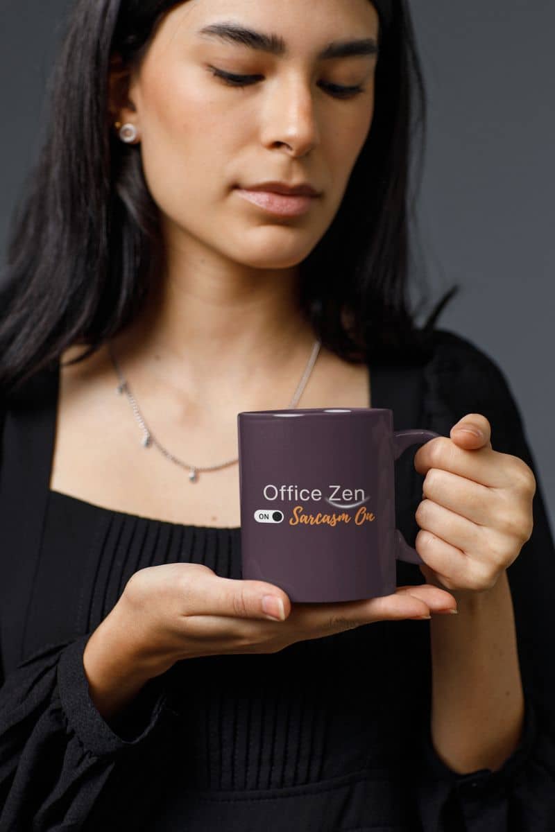 zen coffee mug with a woman holding a purple mug with 'Office Zen' text against a dark background