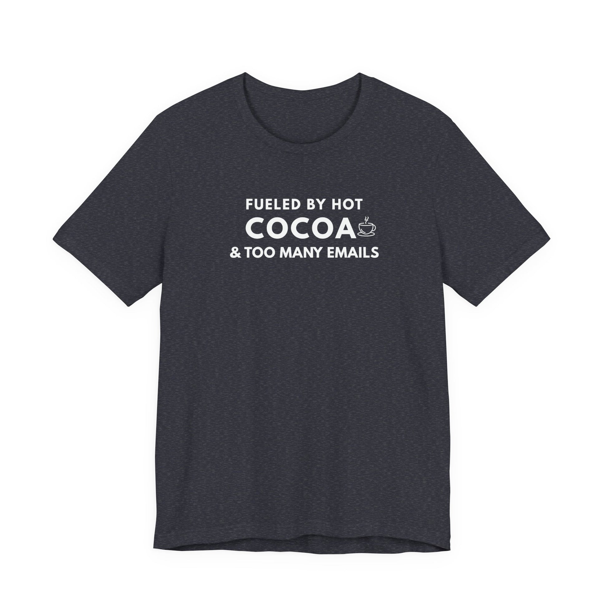 Dark gray t-shirt with white text 'Fueled by hot cocoa & too many emails' on a white background
