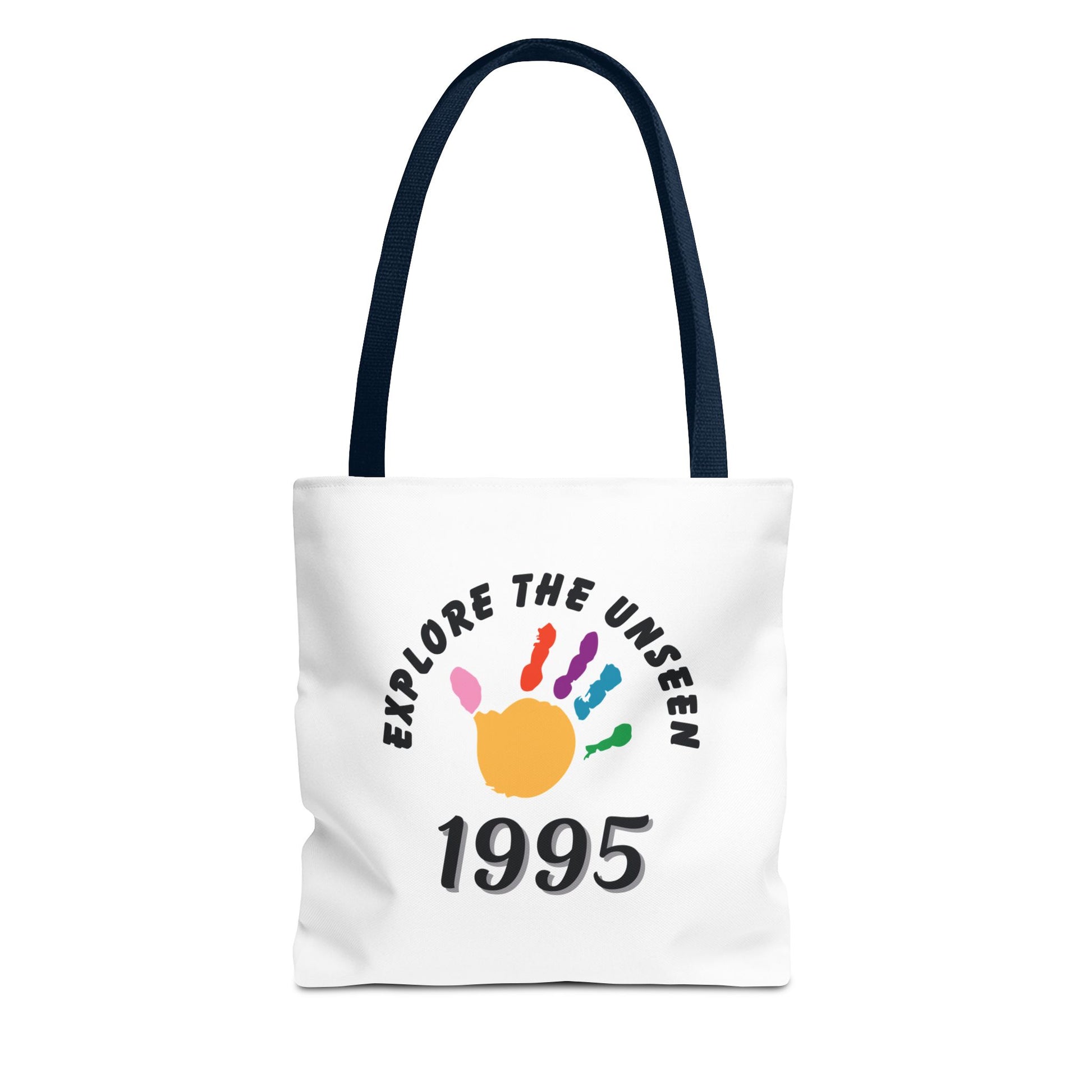 White tote bag with navy handle and text 'Explore the Unseen, 1995' on a white background