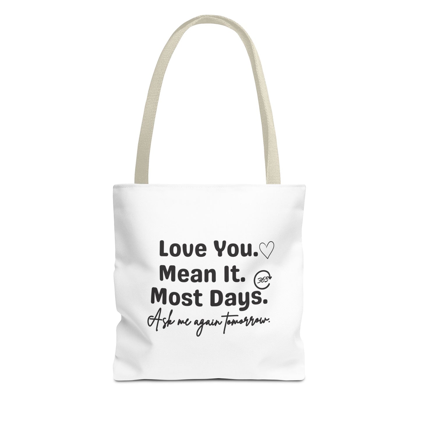 White tote bag with beige handle and text 'Love You. Mean It. Most Days. Ask me again tomorrow.' on a white background