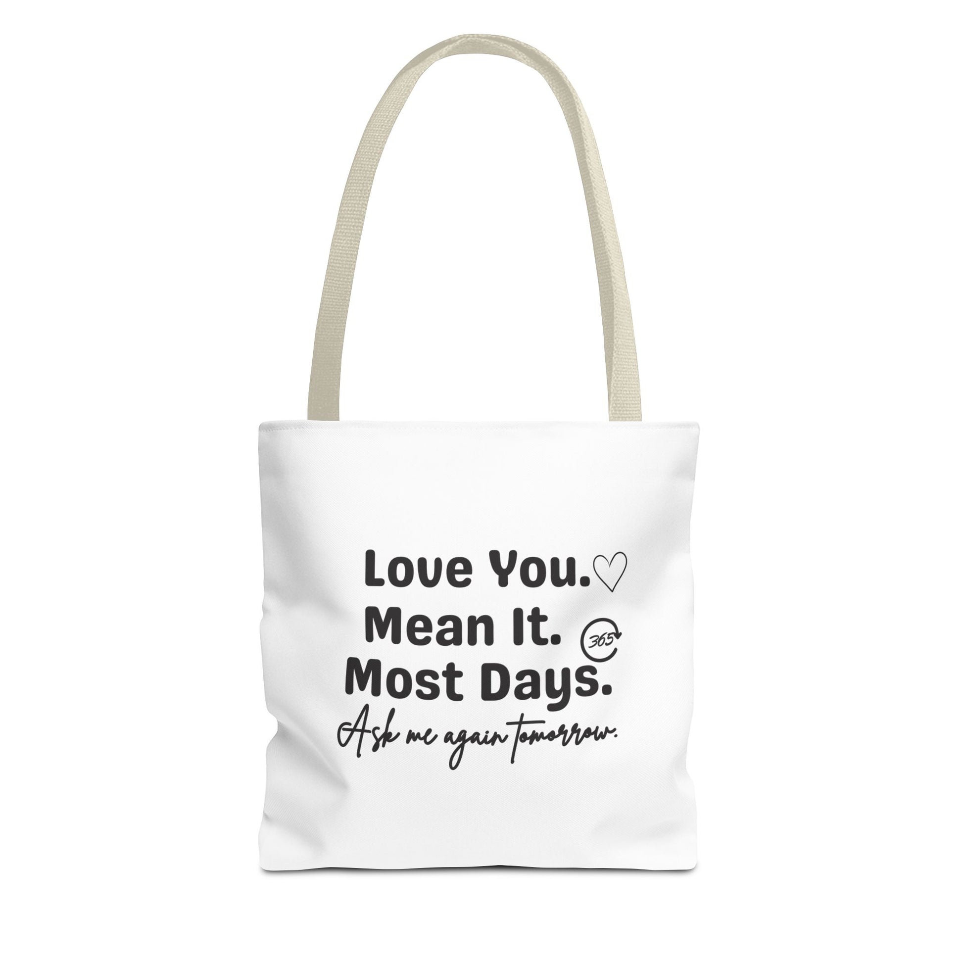 White tote bag with beige handle and text 'Love You. Mean It. Most Days. Ask me again tomorrow.' on a white background