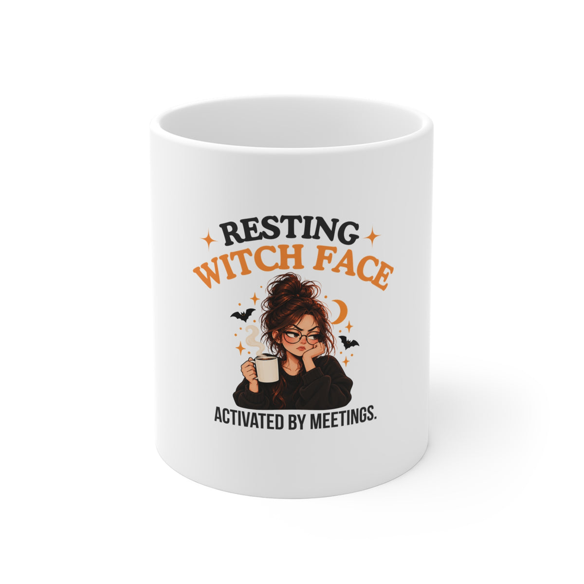 A white ceramic mug with a Halloween-themed graphic that reads 'Resting Witch Face. Activated by Meetings.' featuring an illustrated witch holding a mug, surrounded by bats, stars, and a crescent moon.