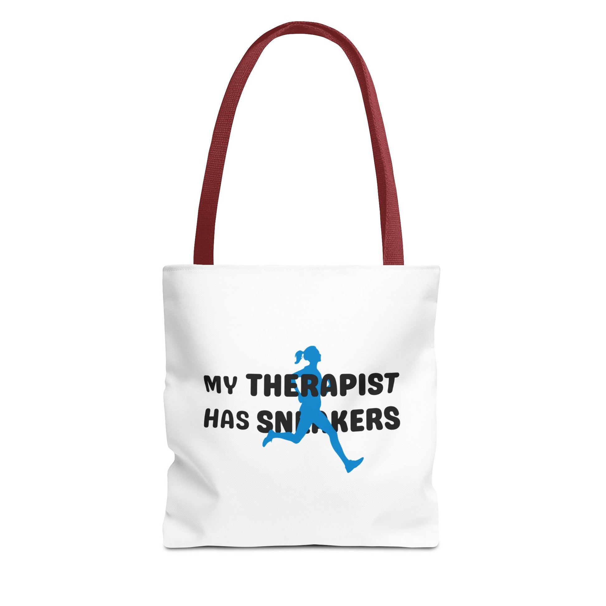 Tote bag with red handle and text 'My Therapist Has Sneakers' on a white background