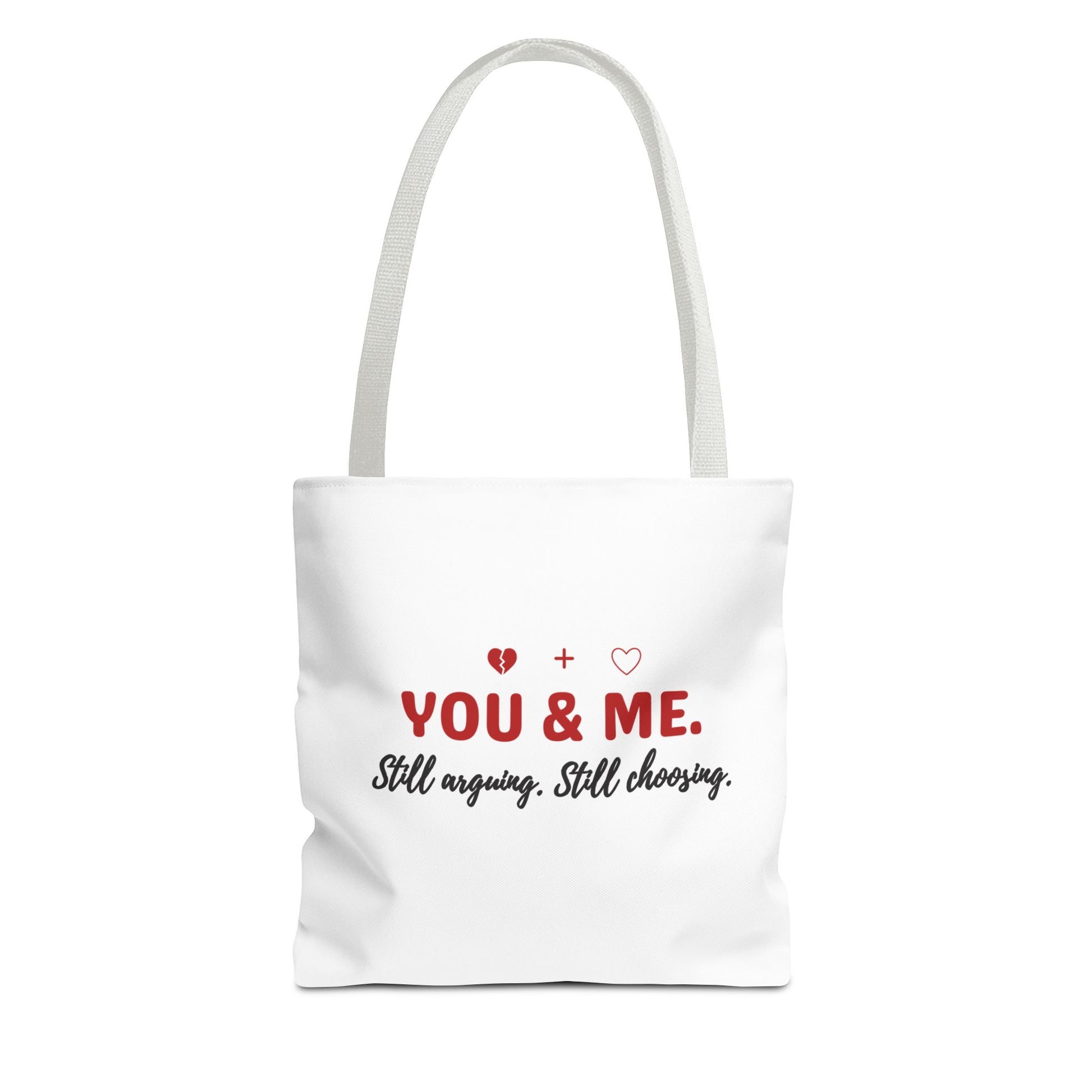 White tote bag with white handle and text 'YOU & ME. Still arguing. Still choosing.' on a white background