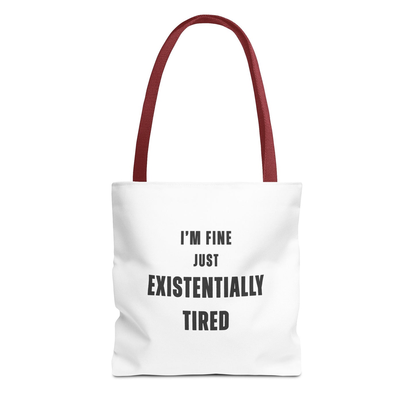 White tote bag with red handles and text 'I’m fine. Just existentially tired.' on a white background