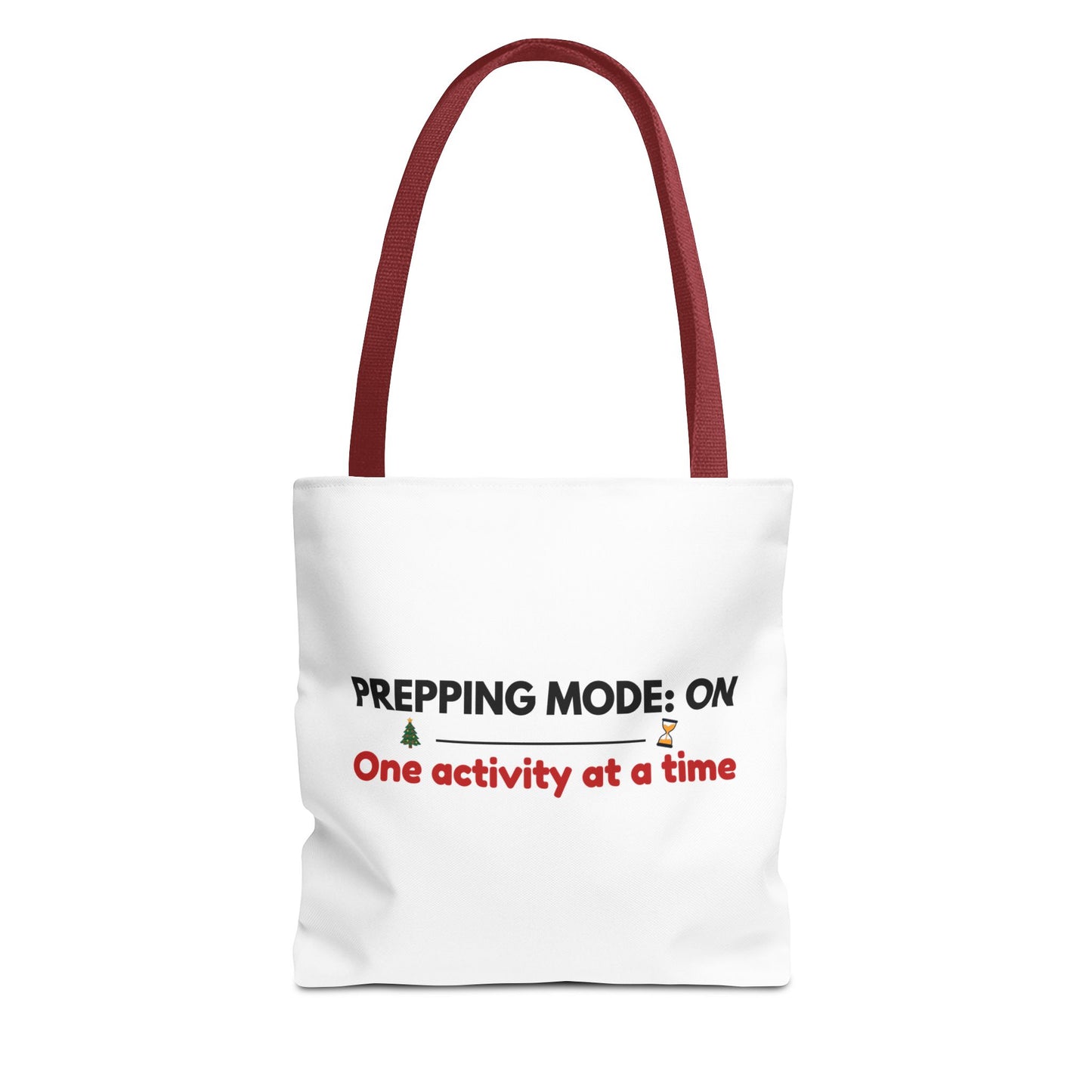 Tote bag with red handle and text 'Prepping Mode: On One Activity at a Time' on a white background