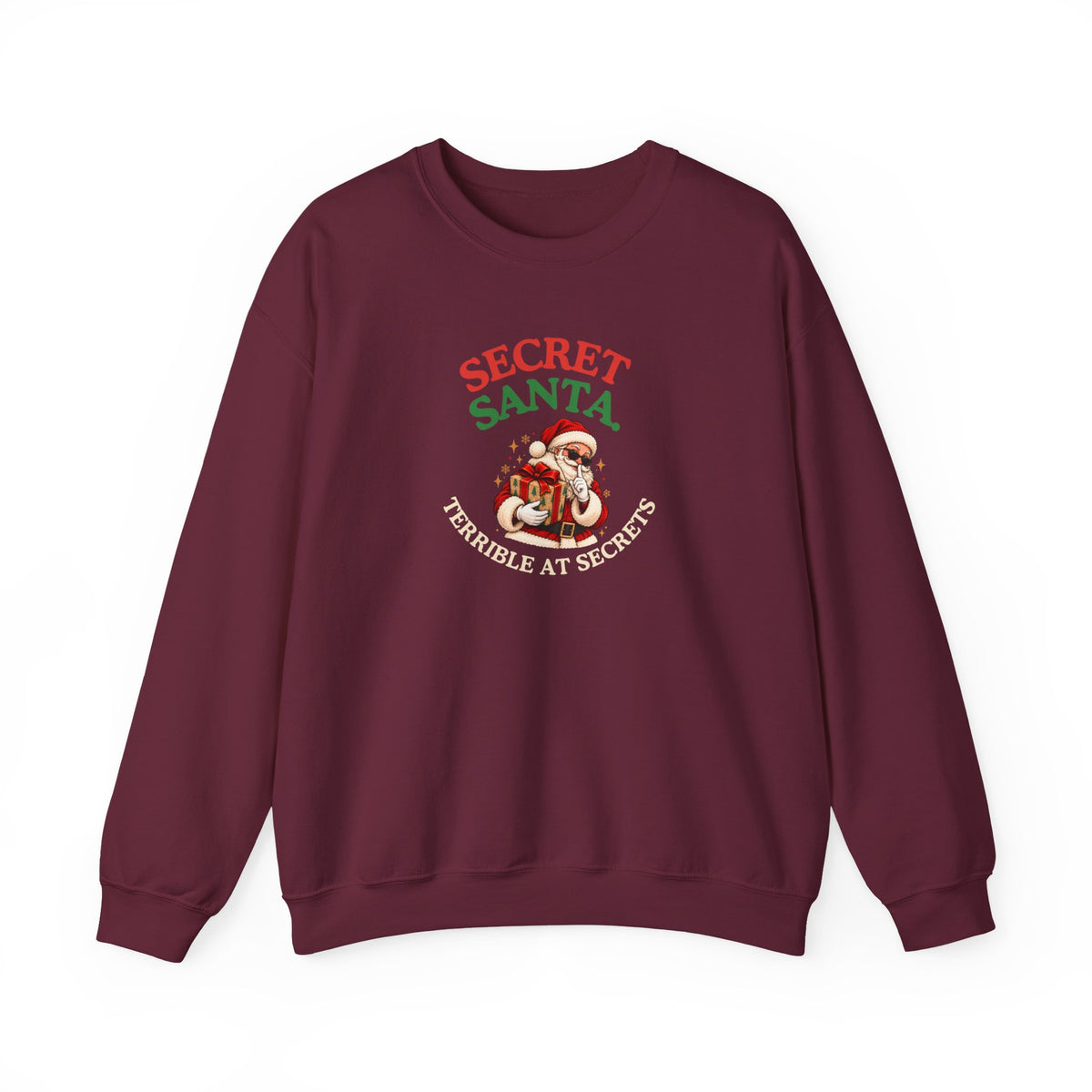 A maroon sweatshirt featuring the text 'Secret Santa. Terrible at Secrets.' with a Santa illustration