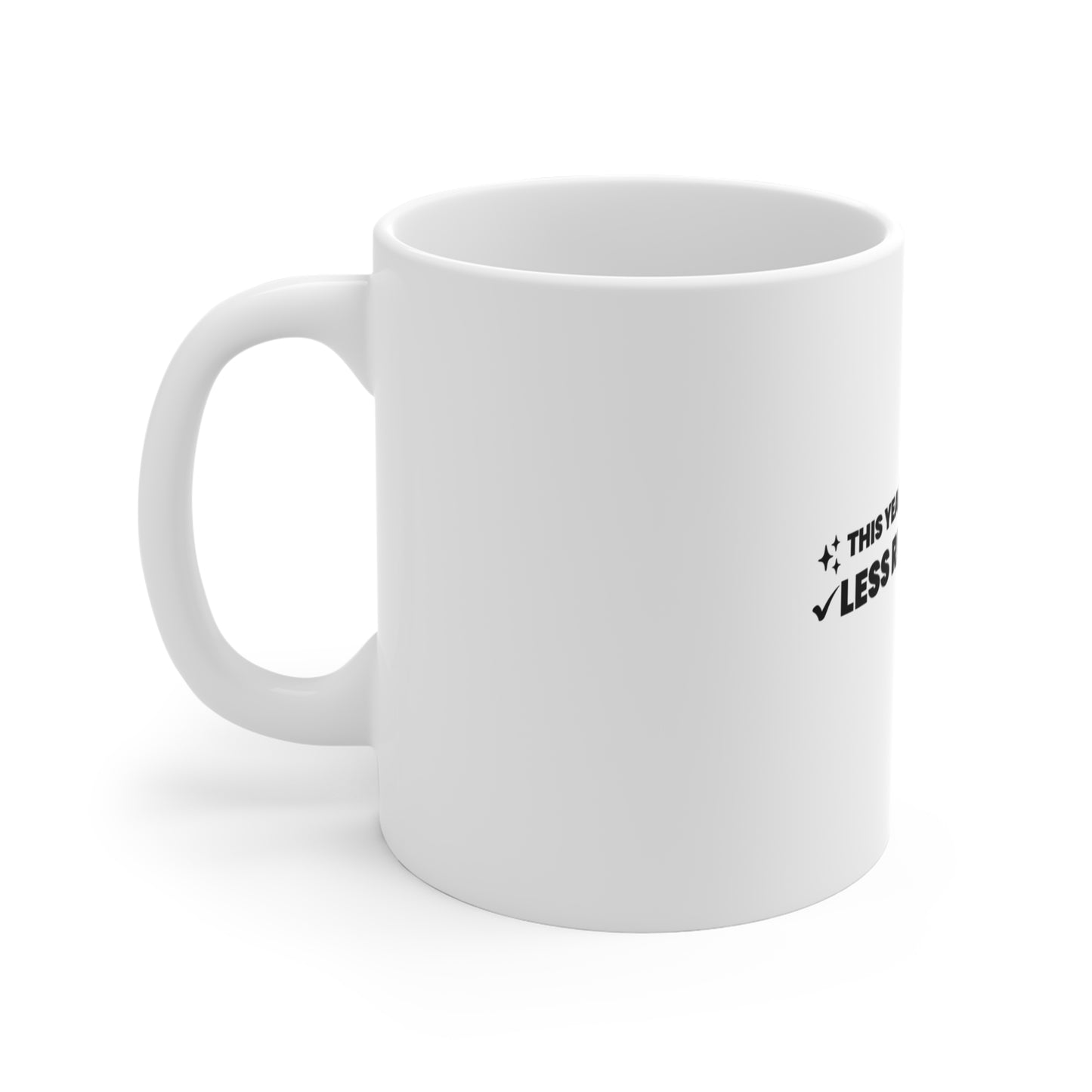 Left side of white mug with text 'This year’s resolution: Less resolutions.' on a white background