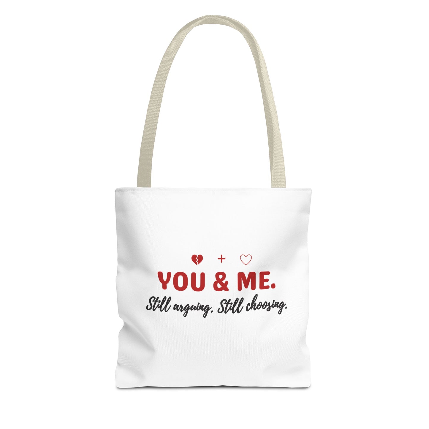 White tote bag with beige handle and text 'YOU & ME. Still arguing. Still choosing.' on a white background