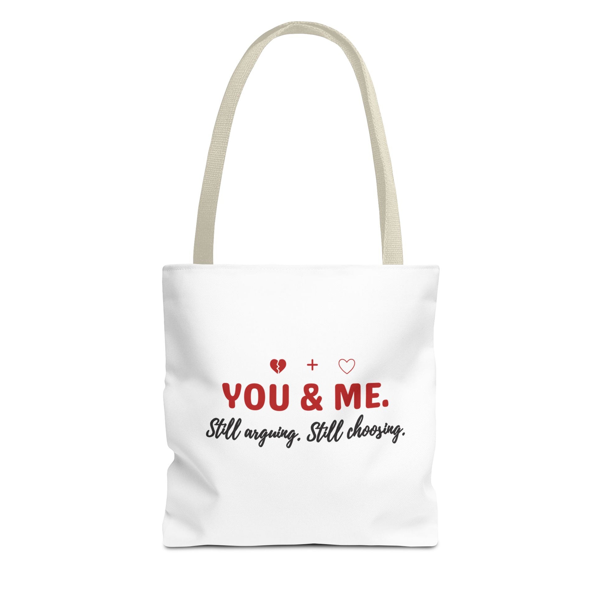 White tote bag with beige handle and text 'YOU & ME. Still arguing. Still choosing.' on a white background