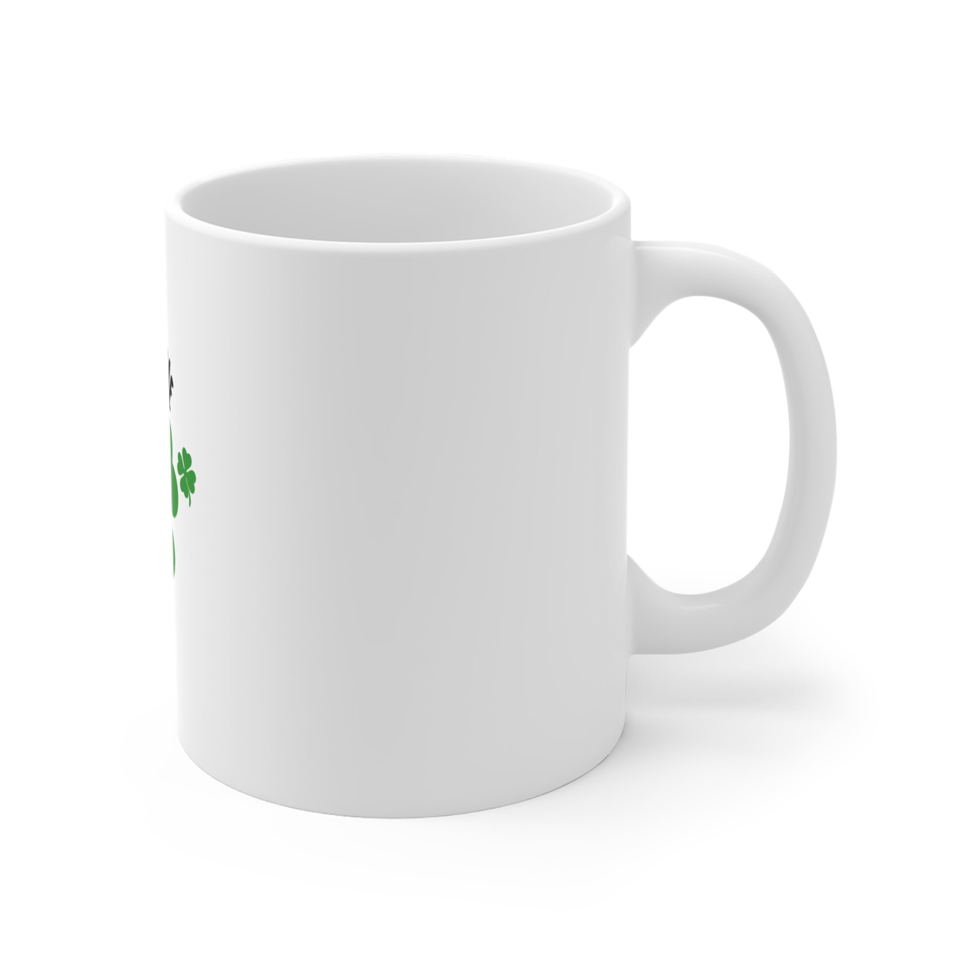 Right side of white mug with a green clover design on a white background