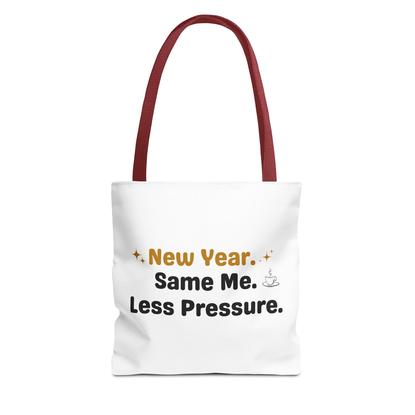 White tote bag with red handle and text 'New Year. Same Me. Less Pressure.' and handle on a white background
