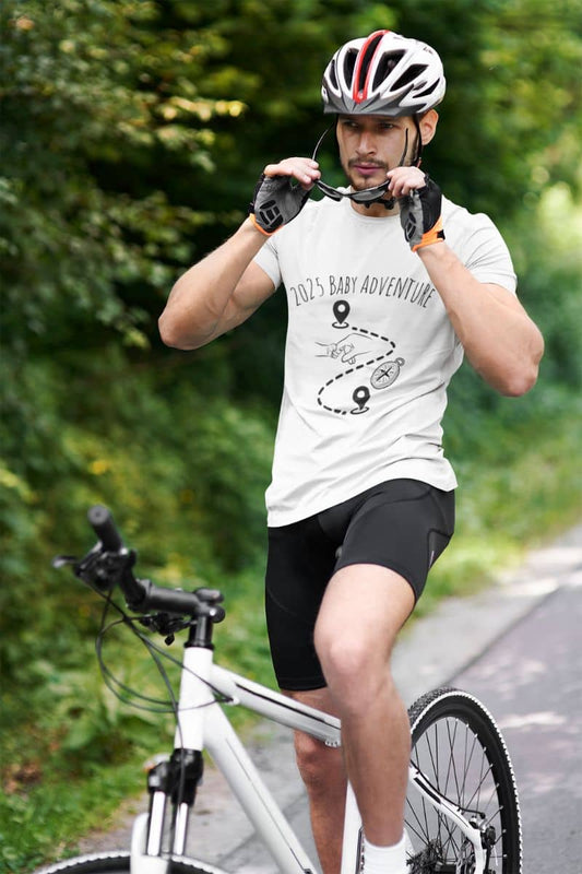 2025 Baby Adventure T-Shirt with a man who is wearing glasses to prepare for a bicycle trip