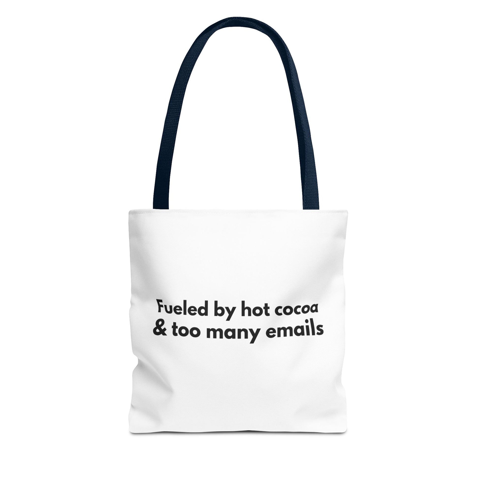 White tote bag with navy handle and text 'Fueled by hot cocoa & too many emails' on a white background
