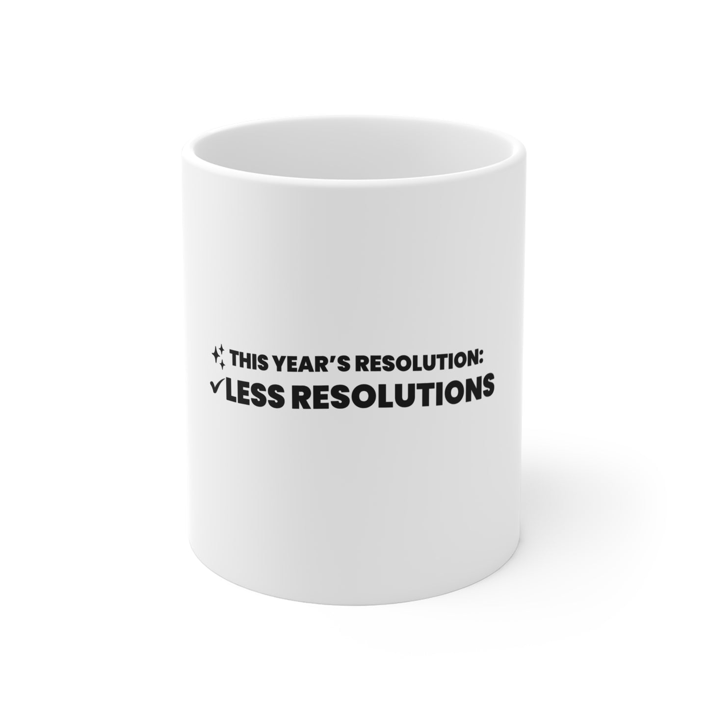 White mug with black text 'This year's resolution: Less resolutions' on a white background