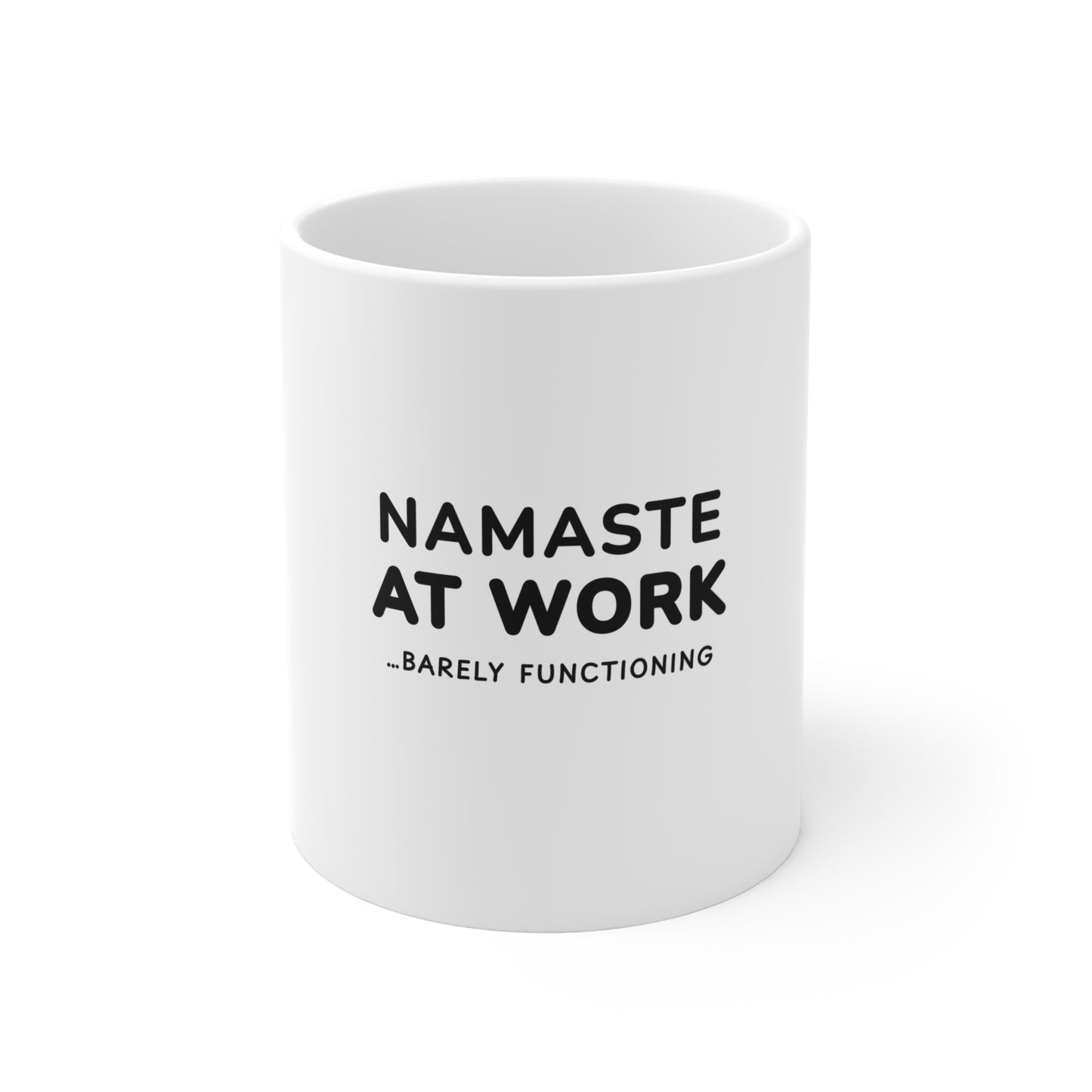White mug with black text 'Namaste at Work...Barely Functioning' on a white background