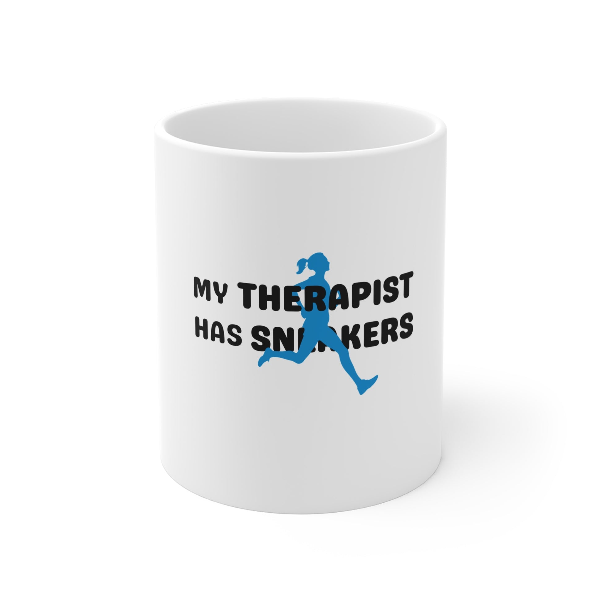 White mug with text 'My Therapist Has Sneakers' and a running person graphic on a white background