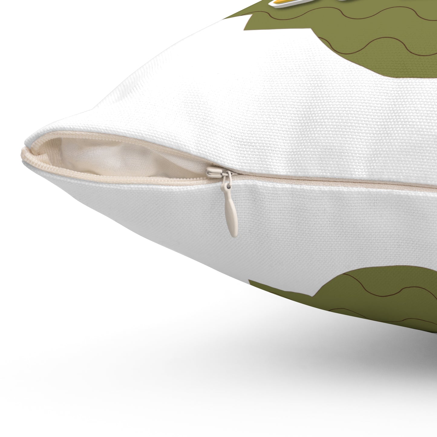 Close-up of a white pillow with green dragon design on a white background