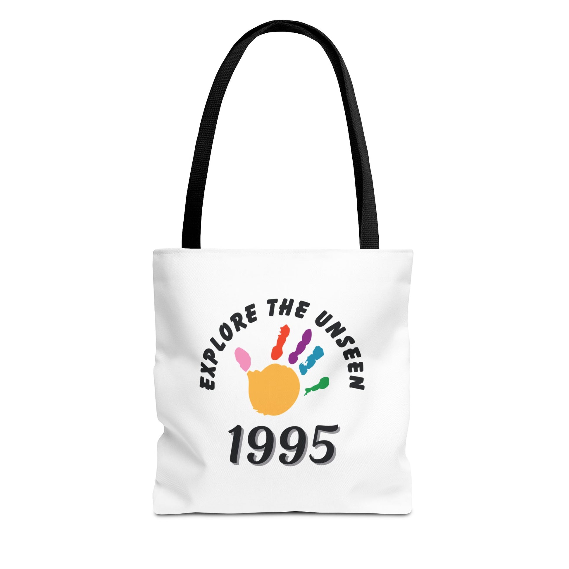 White tote bag with black handle and text 'Explore the Unseen, 1995' on a white background