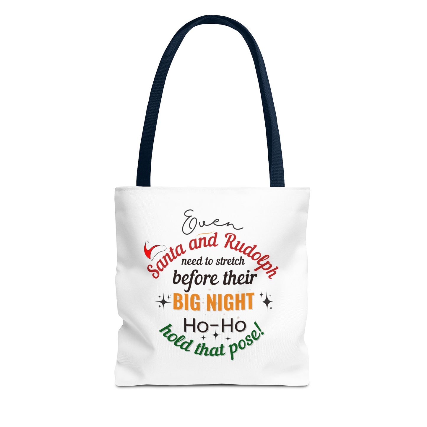 White tote bag with navy handle and text 'Event Santa & Rudolph Need to Stretch Before their Big Night. Ho-Ho-Hold That Pose!' on a white background