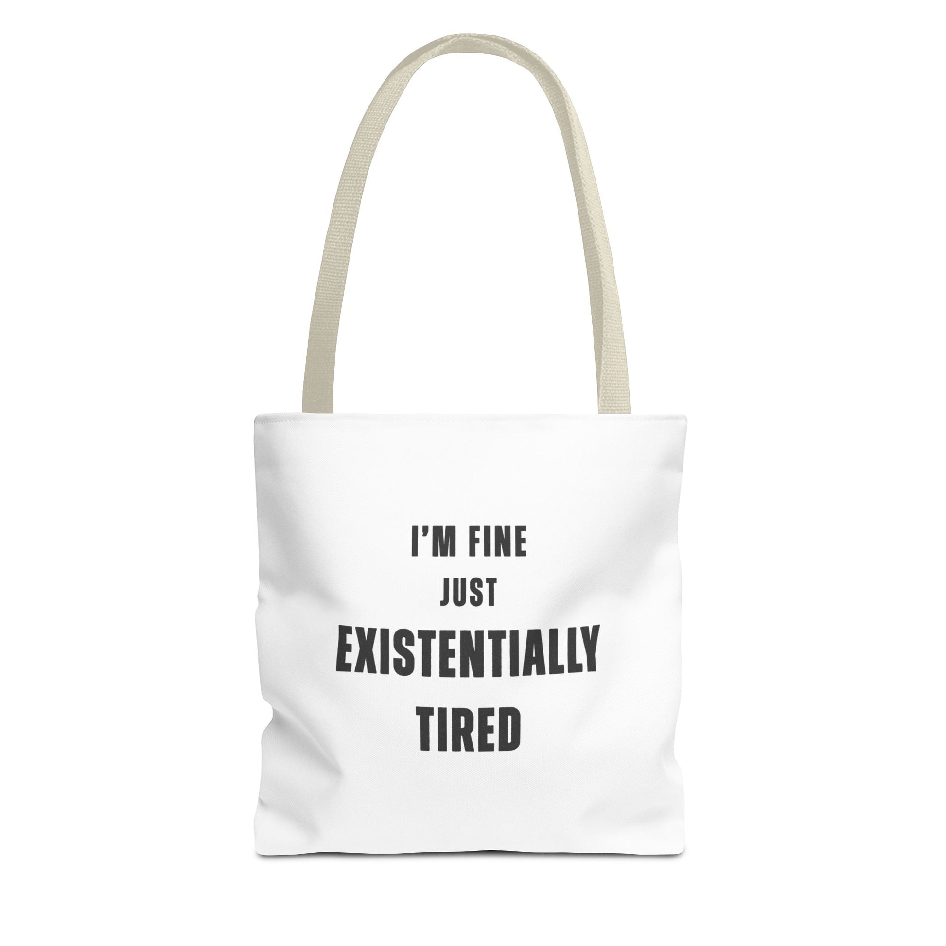 White tote bag with beige handles and text 'I’m fine. Just existentially tired.' on a white background