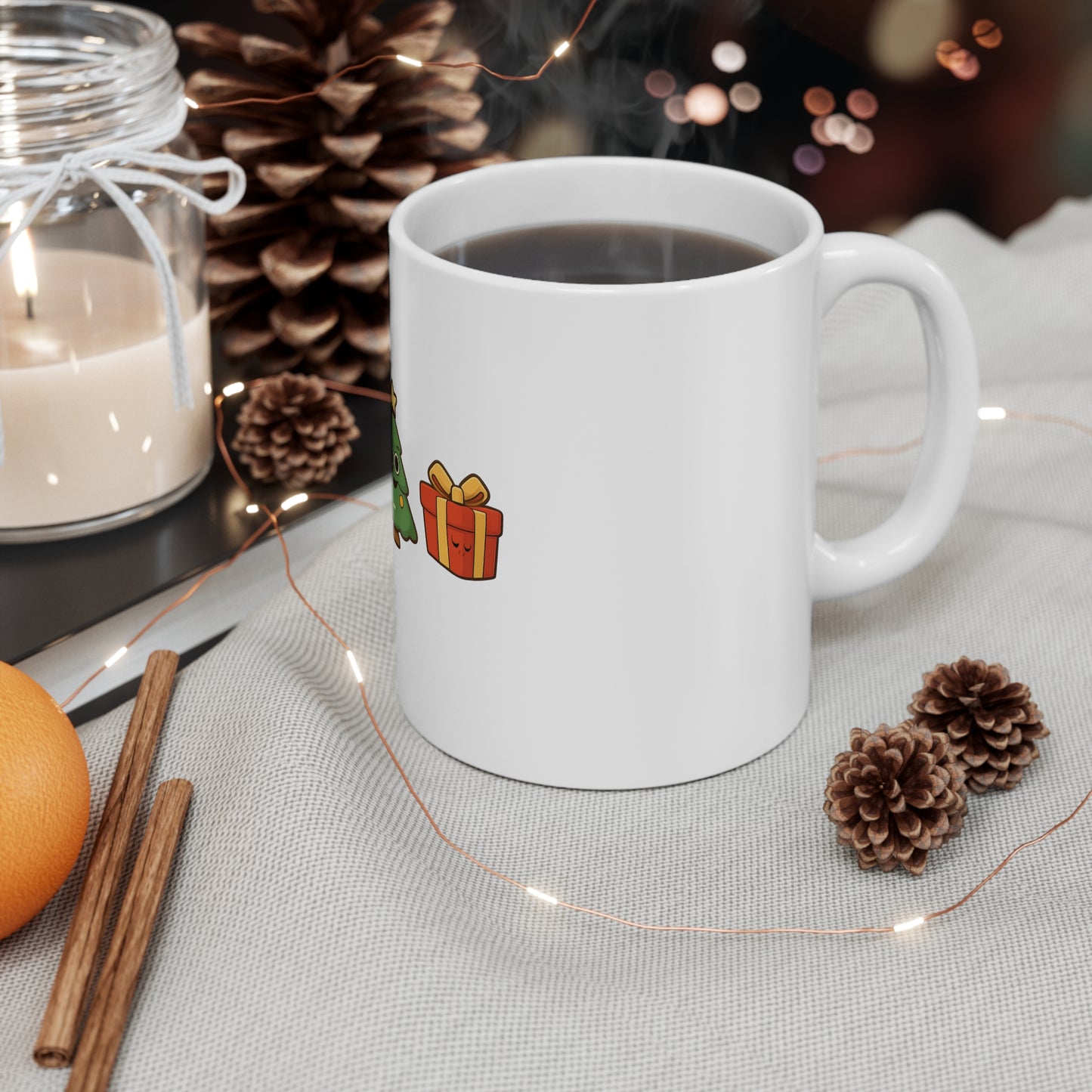 White mug with a gift illustration on a table with decorative items