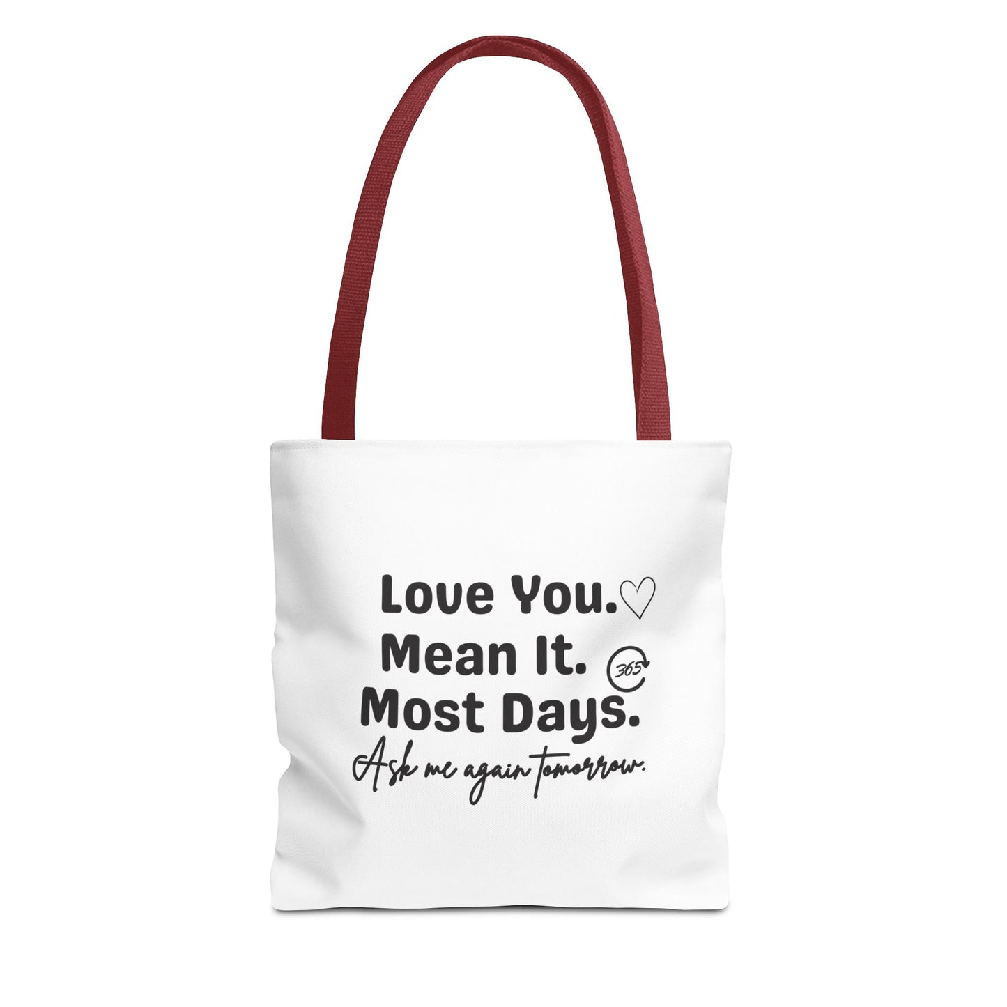 White tote bag with red handle and text 'Love You. Mean It. Most Days. Ask me again tomorrow.' on a white background