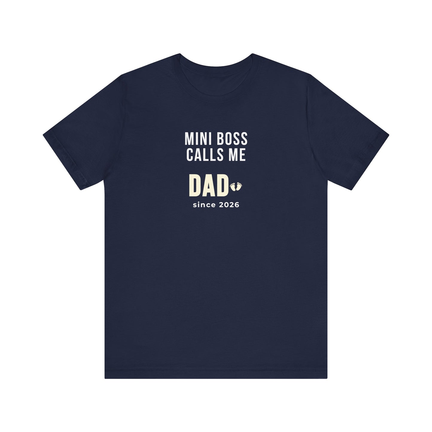 Navy t-shirt with white text 'Mini Boss Calls Me Dad – since 2026' on a white background