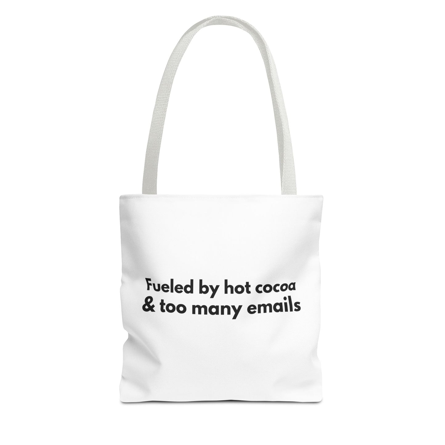 White tote bag with white handle and text 'Fueled by hot cocoa & too many emails' on a white background