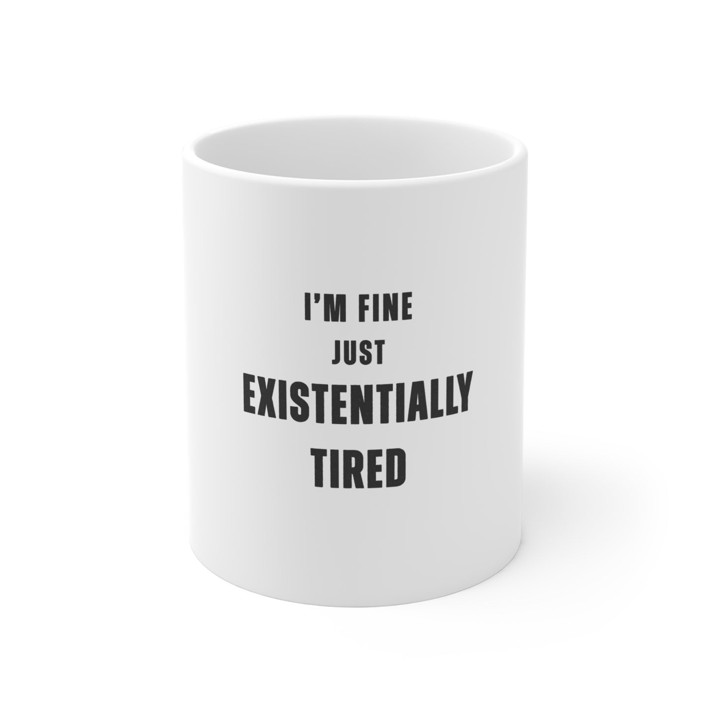 White mug with text 'I'm fine just existentially tired' on a white background