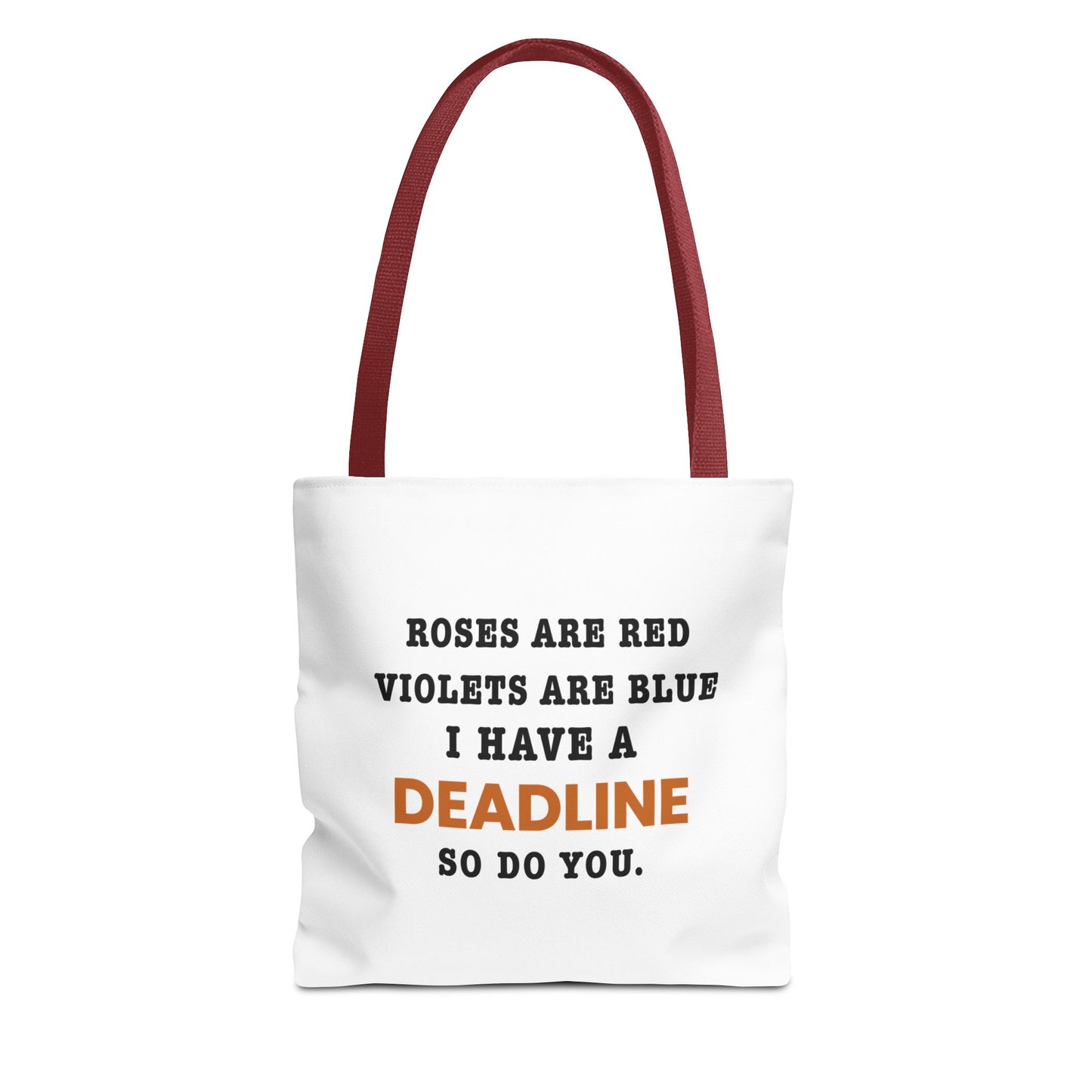 Tote bag with red handles and text 'Roes are red, violets are blue. I have a deadline so you do' on a white background