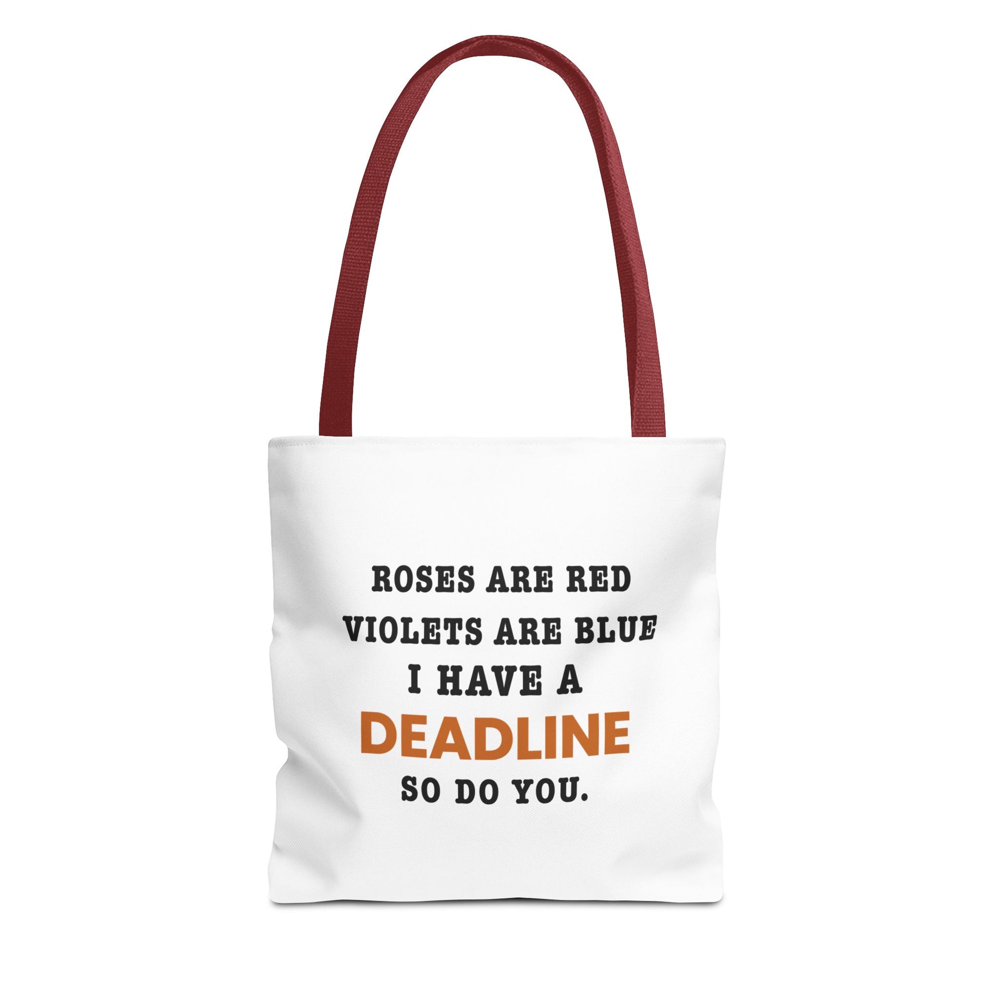 Tote bag with red handles and text 'Roes are red, violets are blue. I have a deadline so you do' on a white background