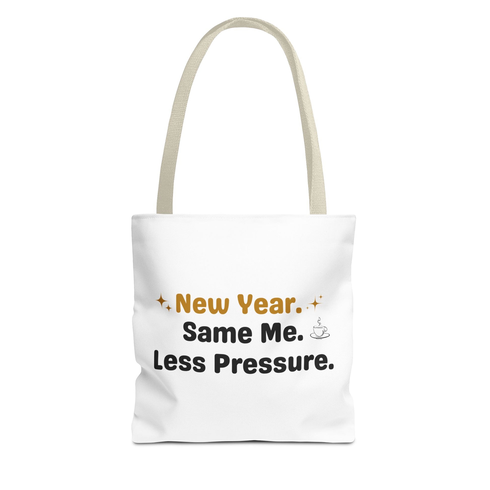 White tote bag with beige handle and text 'New Year. Same Me. Less Pressure.' and handle on a white background