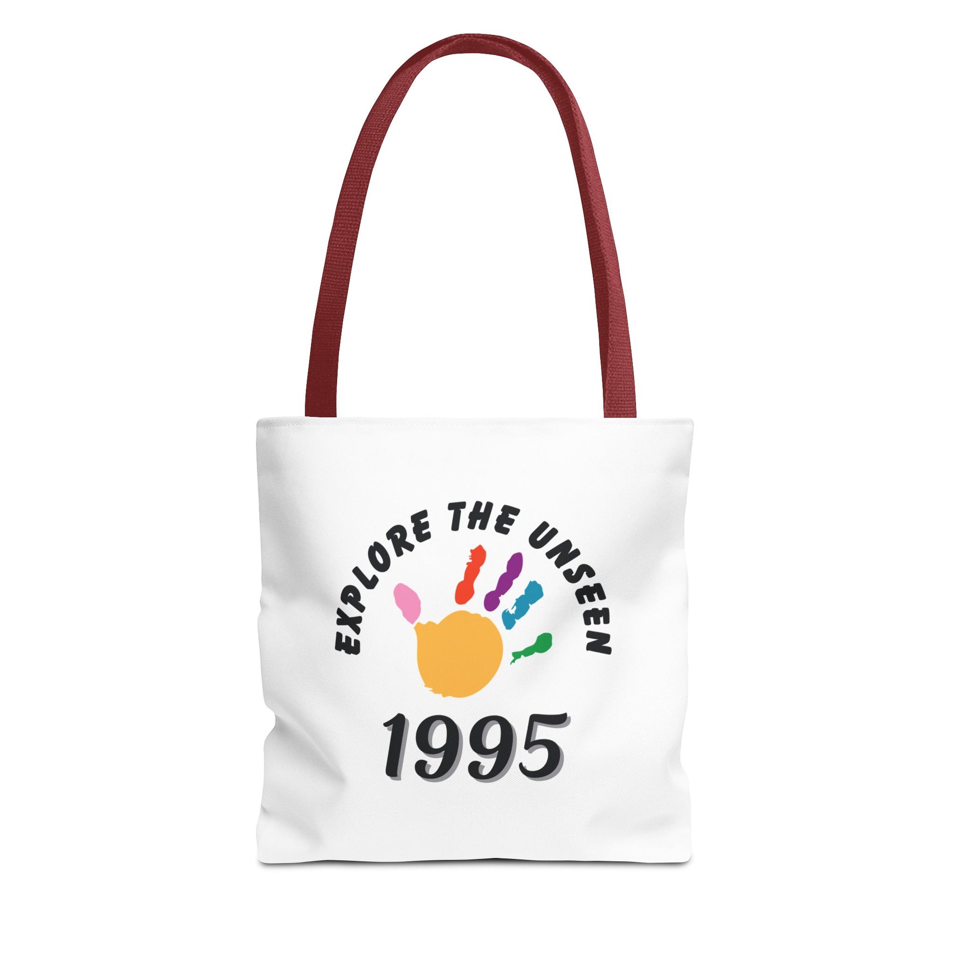 White tote bag with red handle and text 'Explore the Unseen, 1995' on a white background