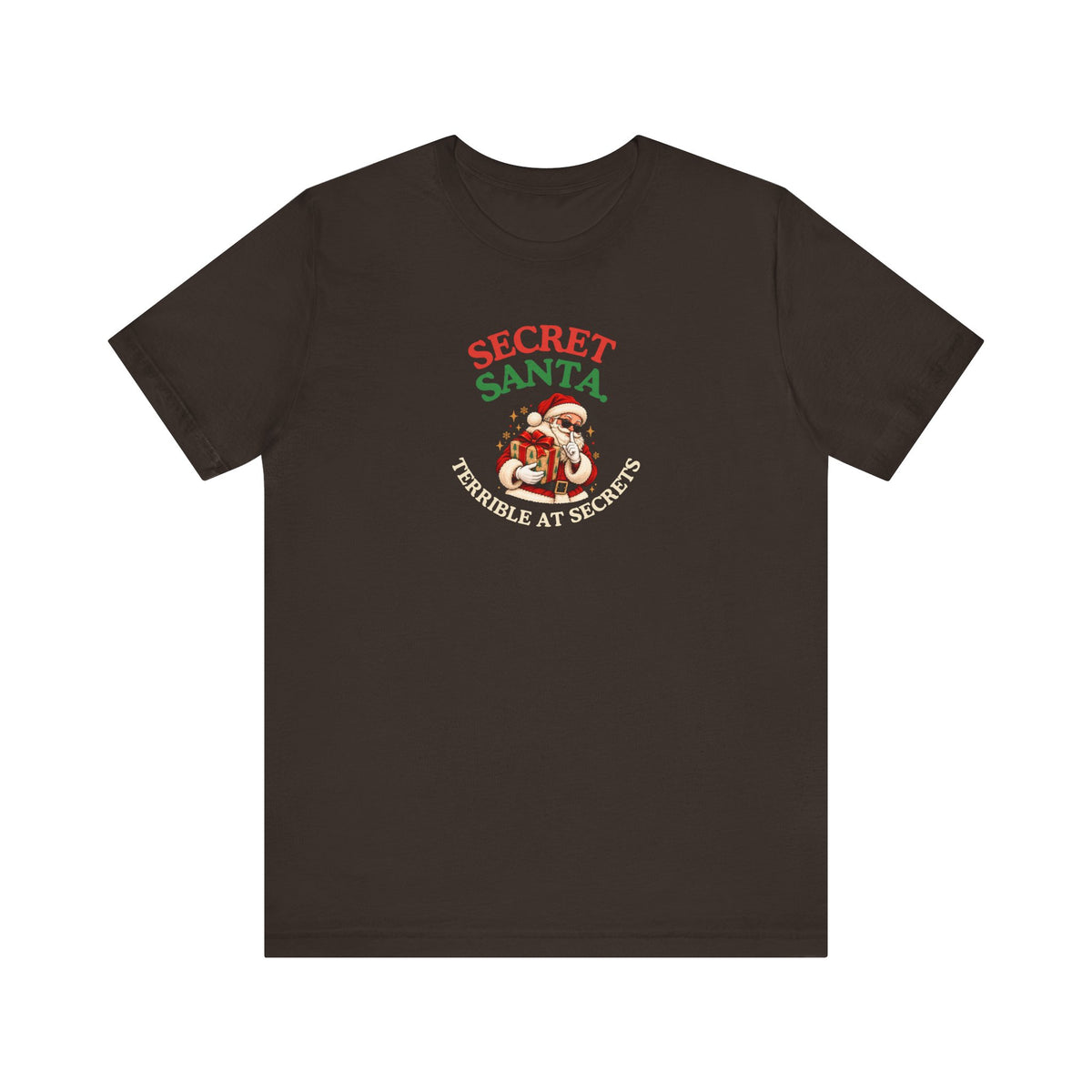 Brown t-shirt featuring the “Secret Santa. Terrible at Secrets.” design on a white background