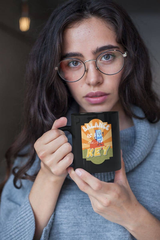 Balance is the key mug with a girl wearing glasses holding a cup of coffee in front of her