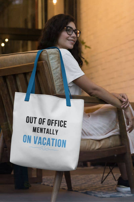 Beach tote bag with a woman sitting on a chair holding a tote bag with text 'Out of Office Mentally On Vacation'.