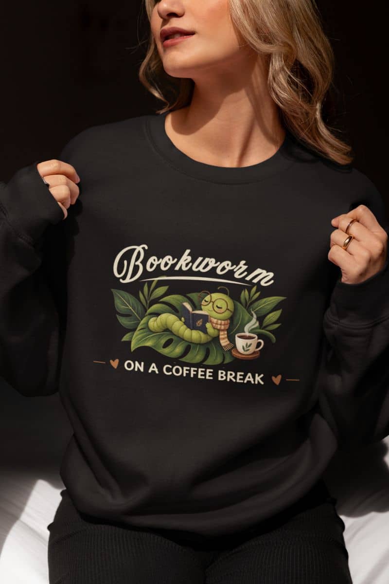 Bookworm sweatshirt with a woman wearing a black crewneck sweatshirt featuring the text 'Bookworm ON A COFFEE BREAK'.