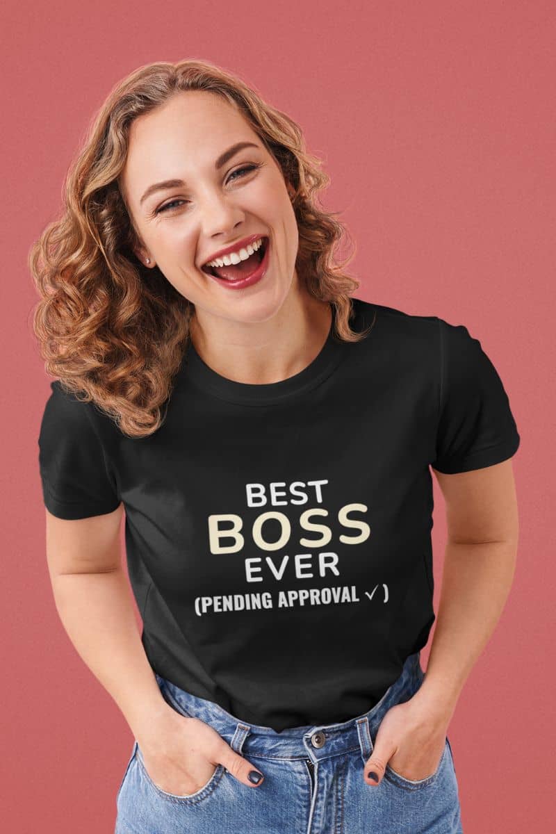 Boss tee shirts with a woman wearing a black t-shirt with text 'Best Boss Ever (Pending Approval)' on a pink background