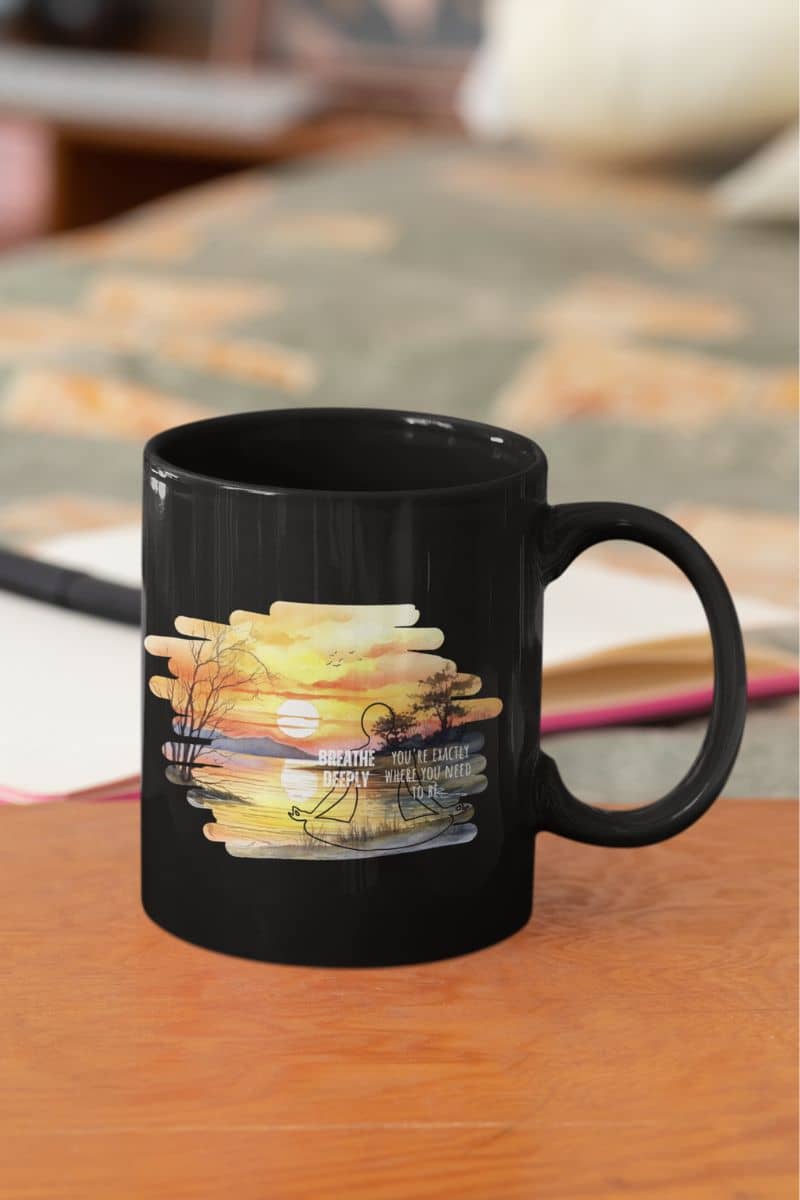 Breathe deeply yoga mug with  a black mug on the table