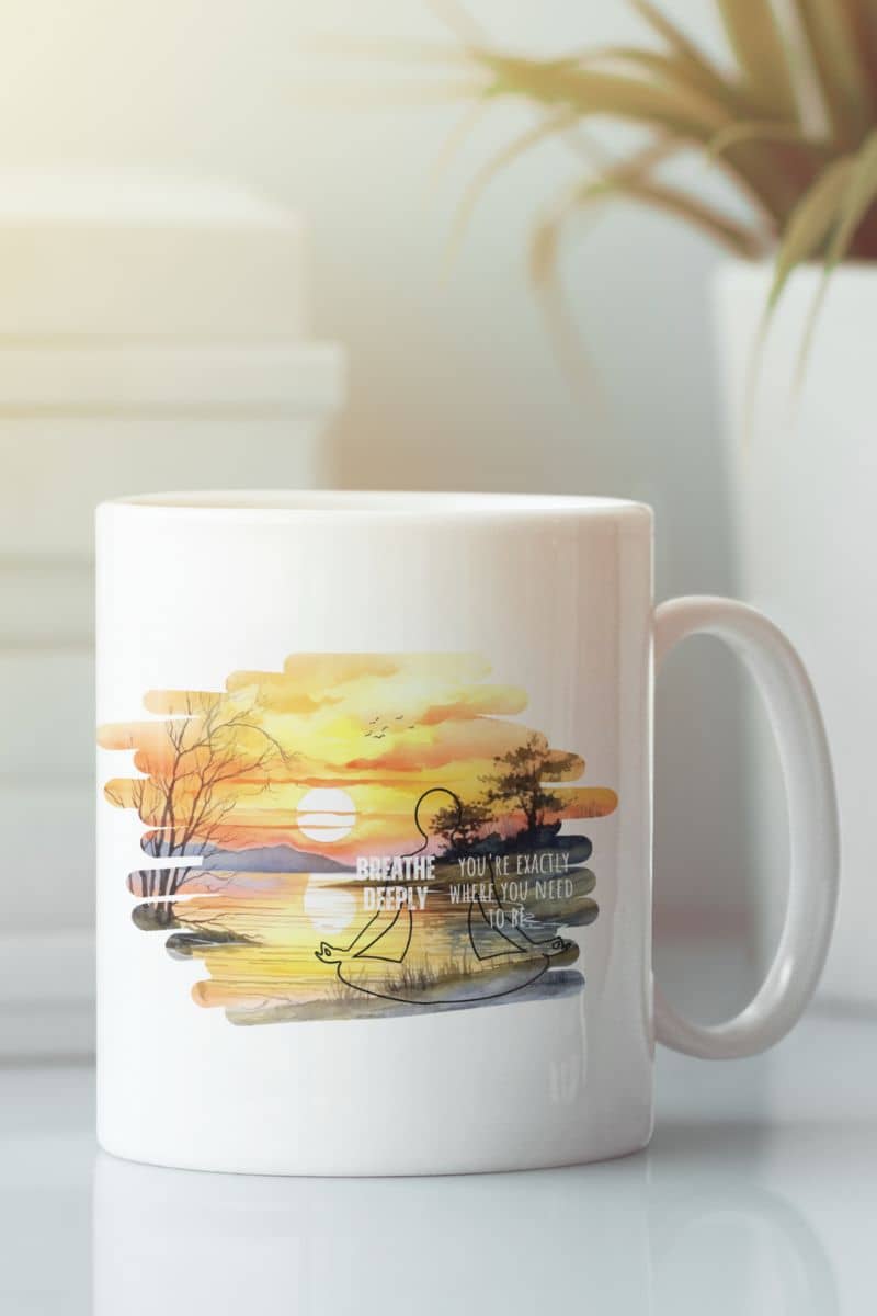 Breathe deeply yoga mug with  a white mug on the table